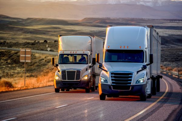 2 semi-trucks driving side by side